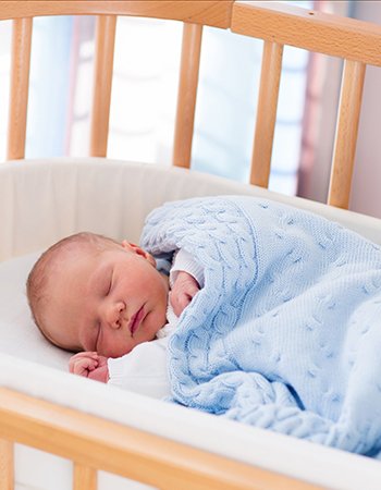 Newborn baby boy in hospital cot MKE